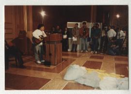 SCENE: TERRY WATADA PLAYS GUITAR AT REDRESS RALLY